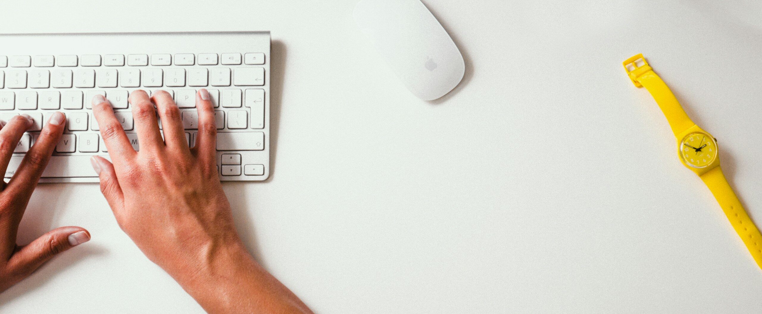 person typing on Apple Cordless Keyboard