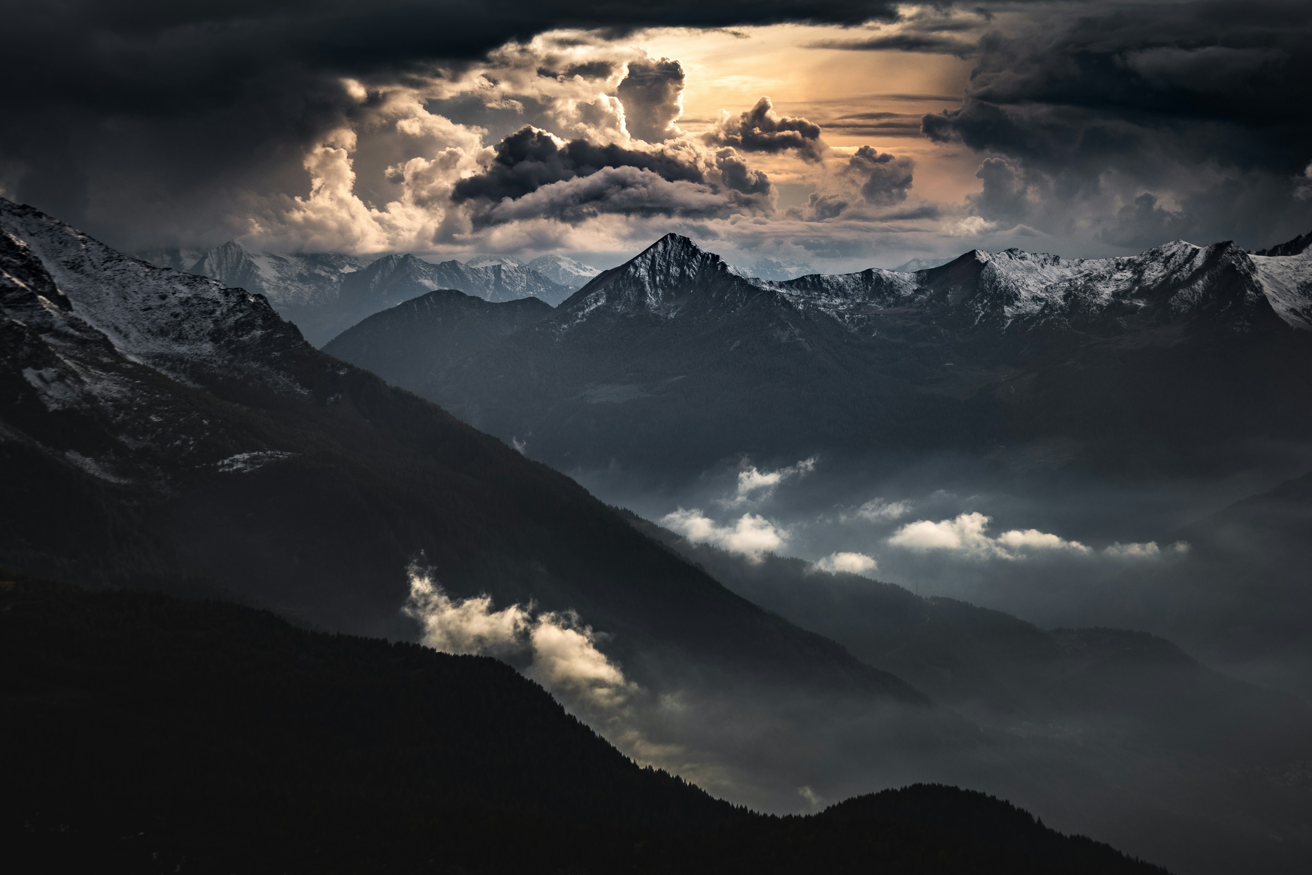 black and white mountains under white clouds during daytime