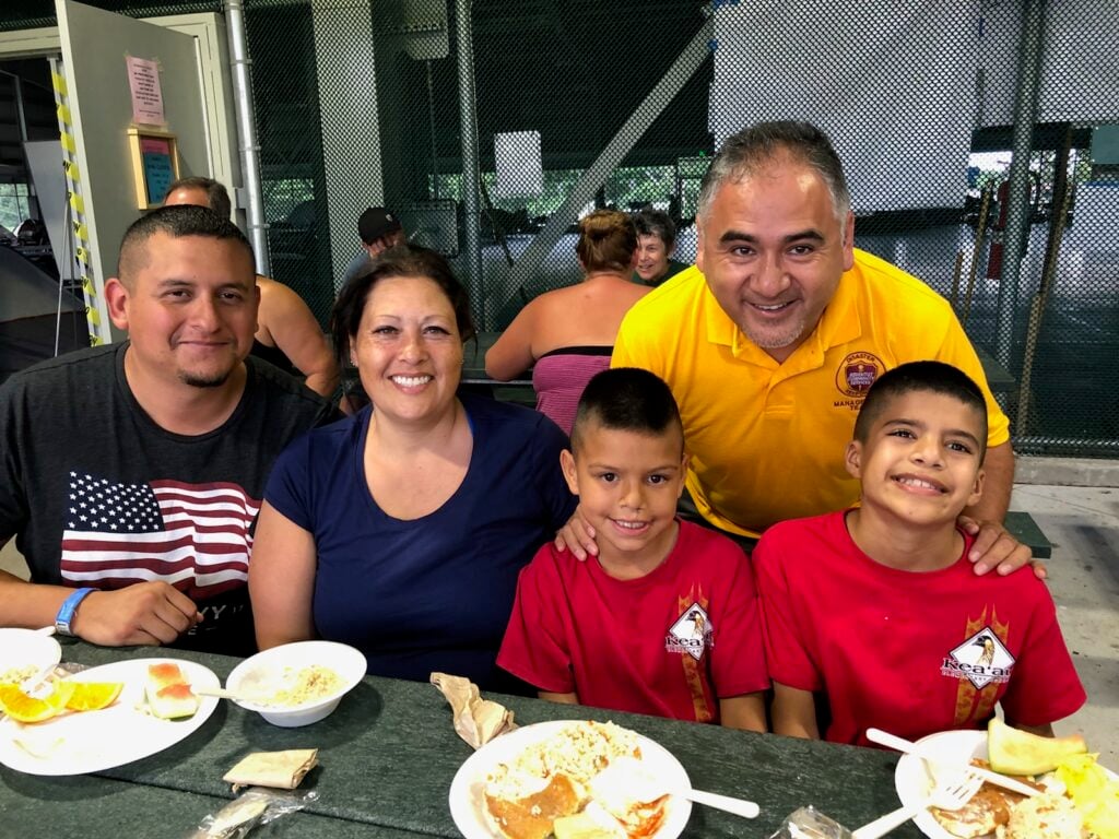 Pastor Rene Lopez encourages a family staying in one of the shelters on Big Island after they lost their home in the recent lava flow