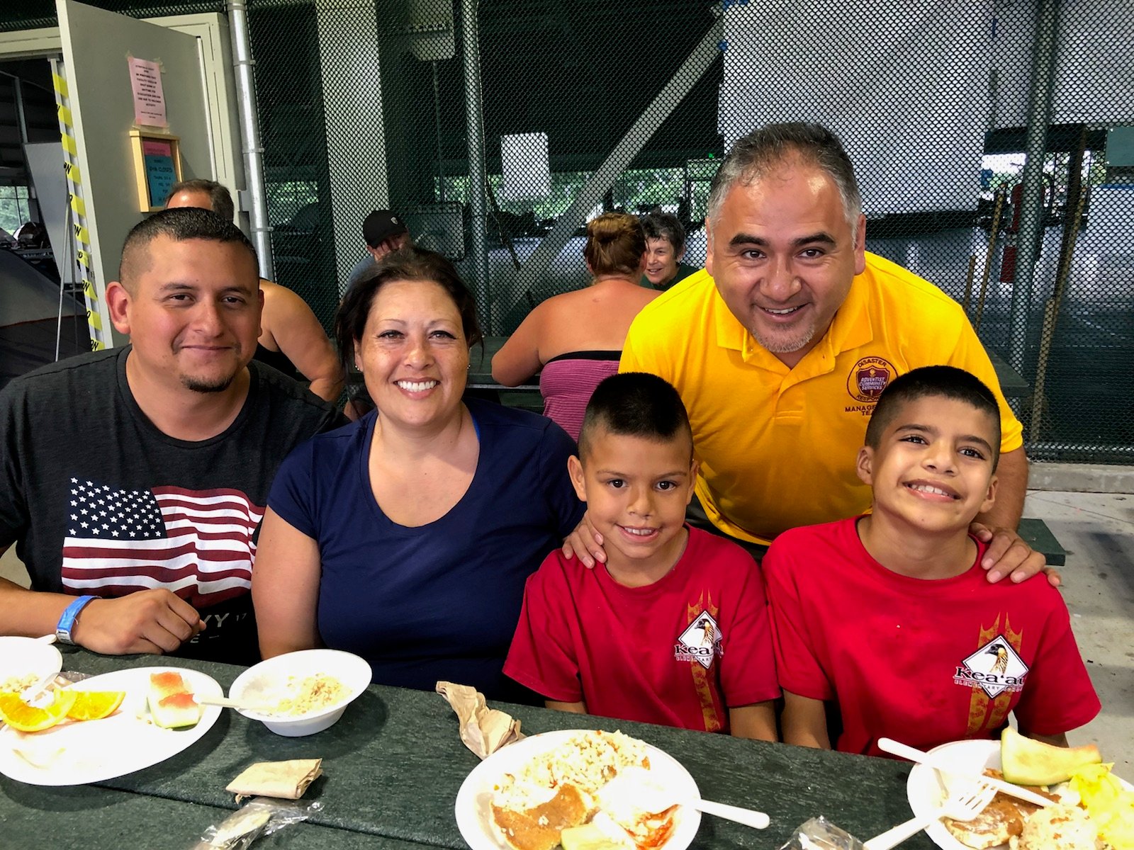 Pastor Rene Lopez encourages a family staying in one of the shelters on Big Island after they lost their home in the recent lava flow