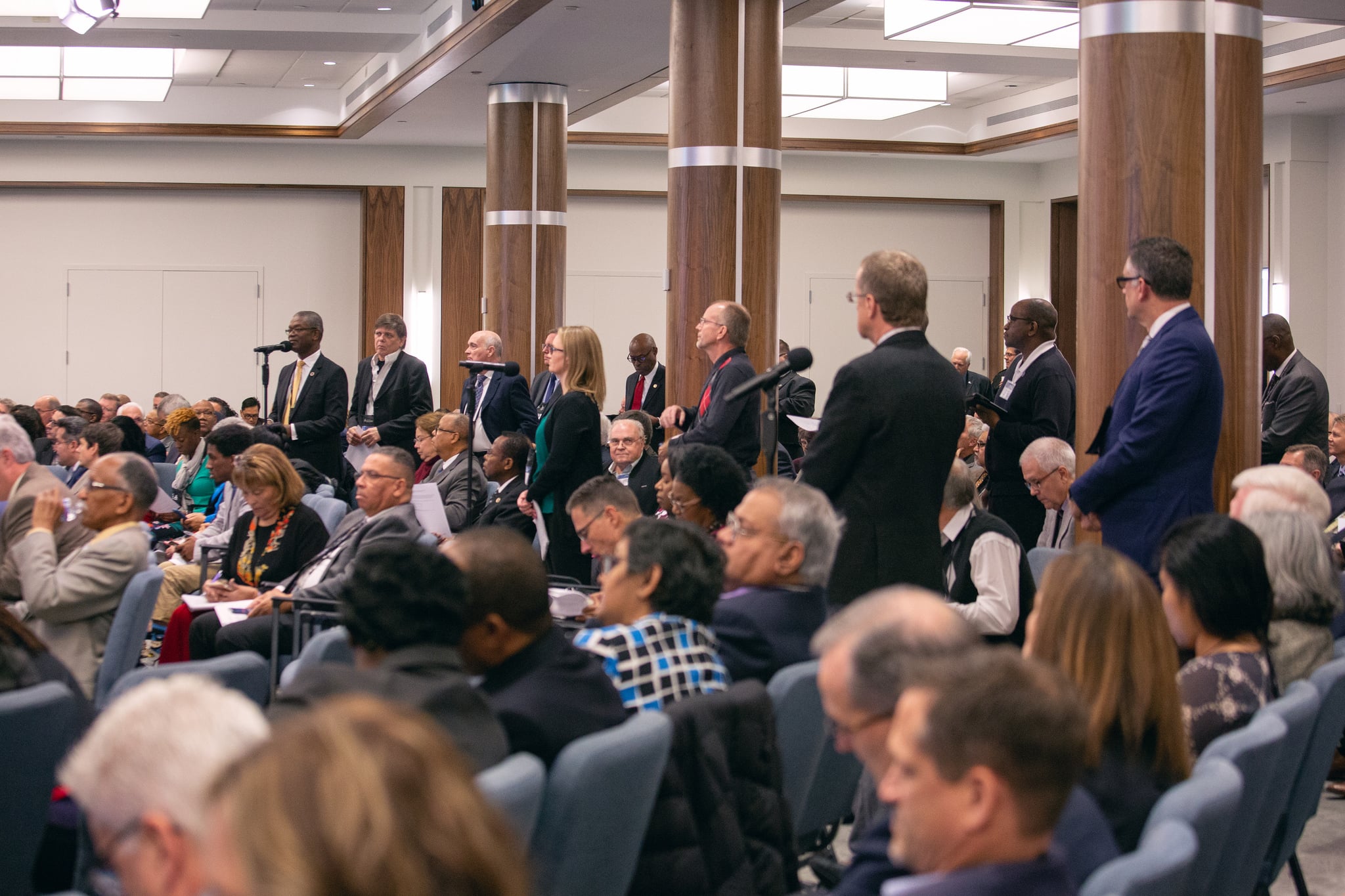 NAD executive committee members line up to speak during the morning discussion on the GC document voted at Annual Council that sets forth the creation of a new compliance process to assist with the need to implement church policies and voted actions.