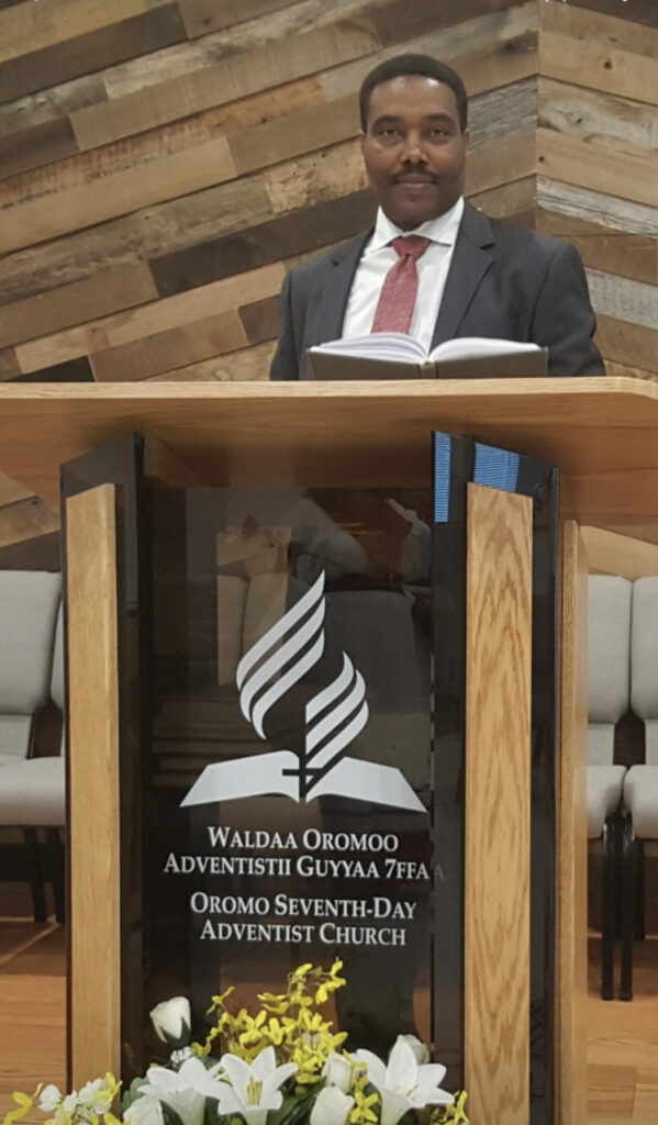 Pastor Desta Gelgelu preaching and live streaming from the church.