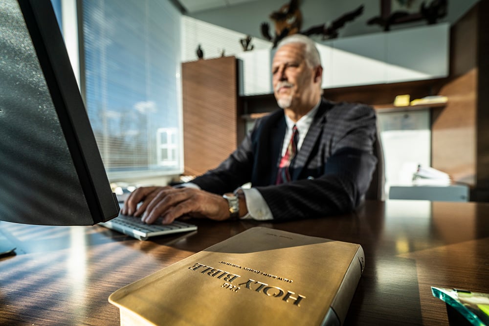 Randy Robinson works at his office desk; photo by Dan Weber