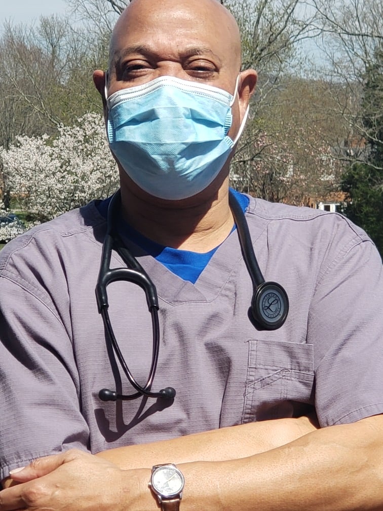 Wayne Moore, an emergency medicine physician, wears a mask as he prepares for work. He says he has been able to survive this time through the prayers and support of his family and friends.