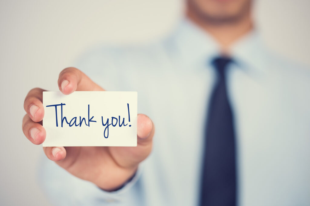 man holding thank you card