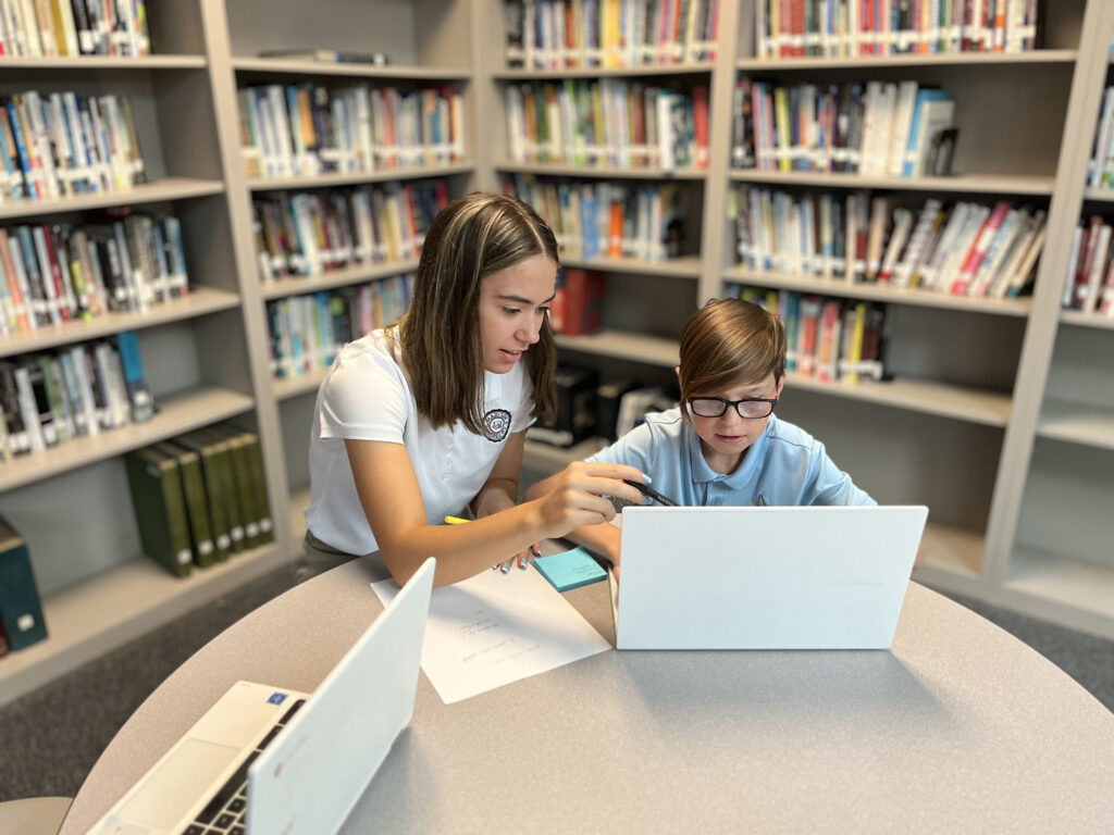 SAU_Aspiring Teachers Clubs_Photo courtesy of SFFC Foundation - photo of student and teacher with computer in a library setting