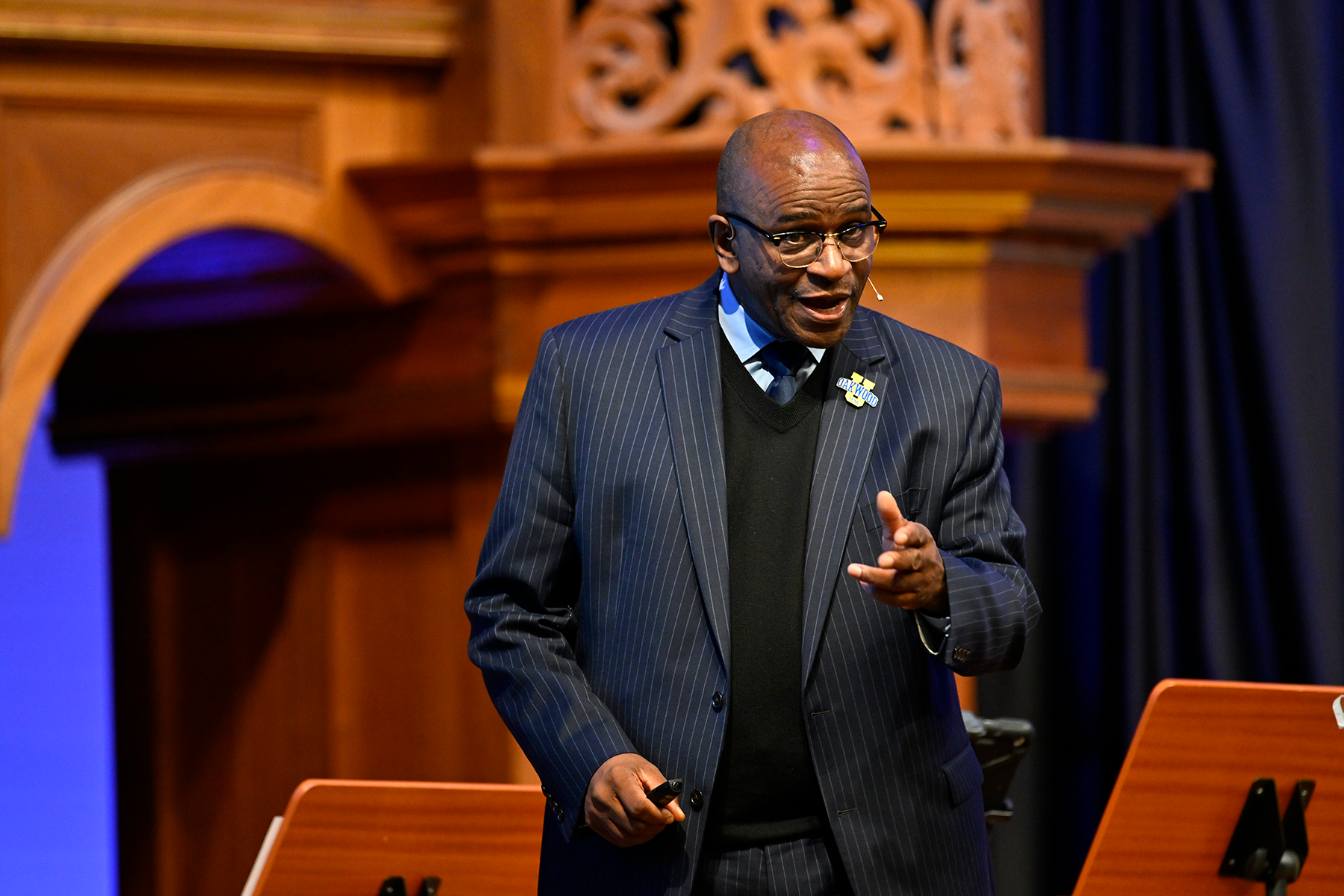 Close-up of black man in a suit speaking to an unseen crowd