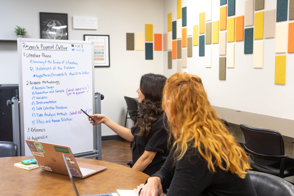 Students review a research proposal outline in the Center for Learning Innovation and Research.