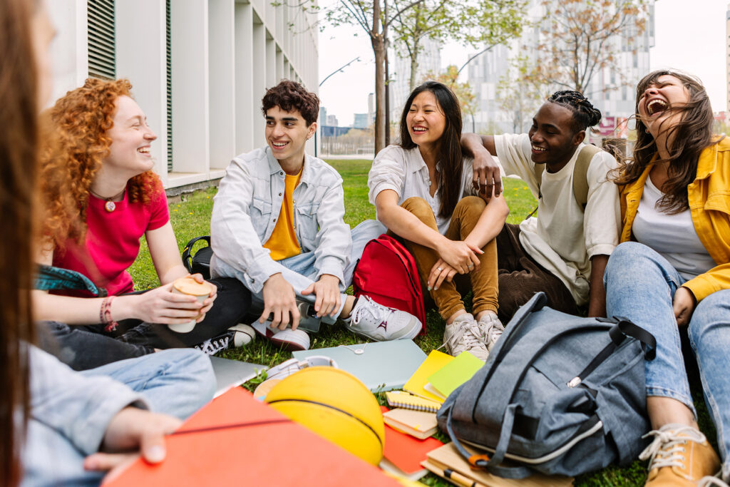 A diverse group of students study outside.