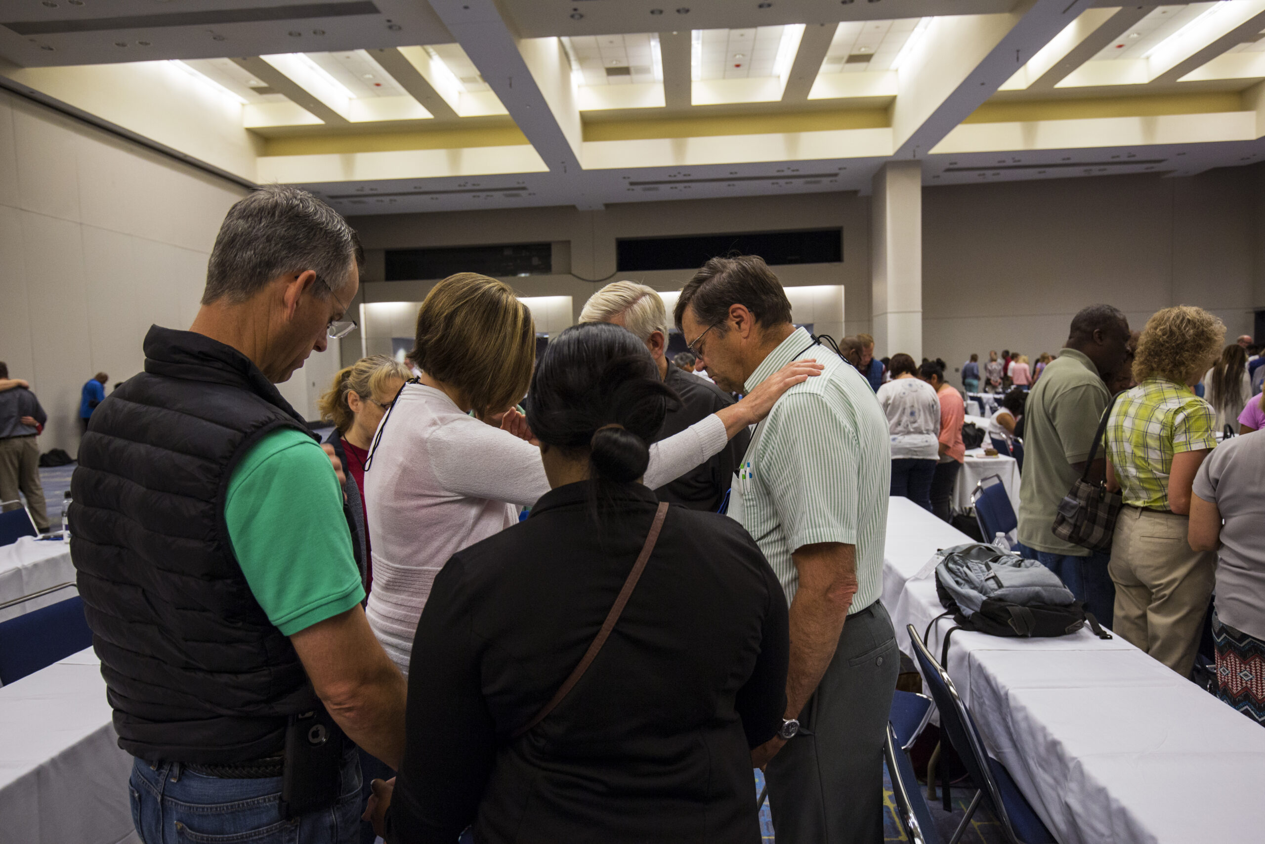 A participant of the anointing service prays over a fellow educator in her small group.