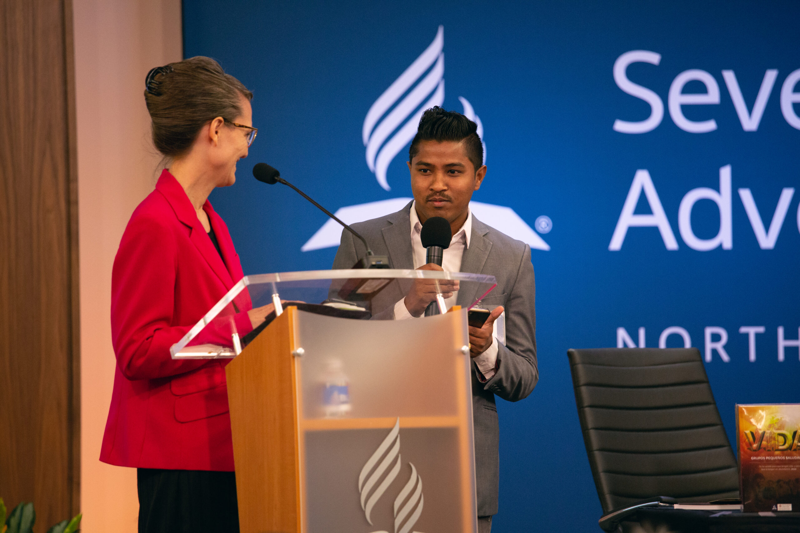 Terri Saelee, NAD coordinator for Refugee and Immigrant Ministries, gives her YEM report with a ministry colleague. Photo by Pieter Damsteegt
