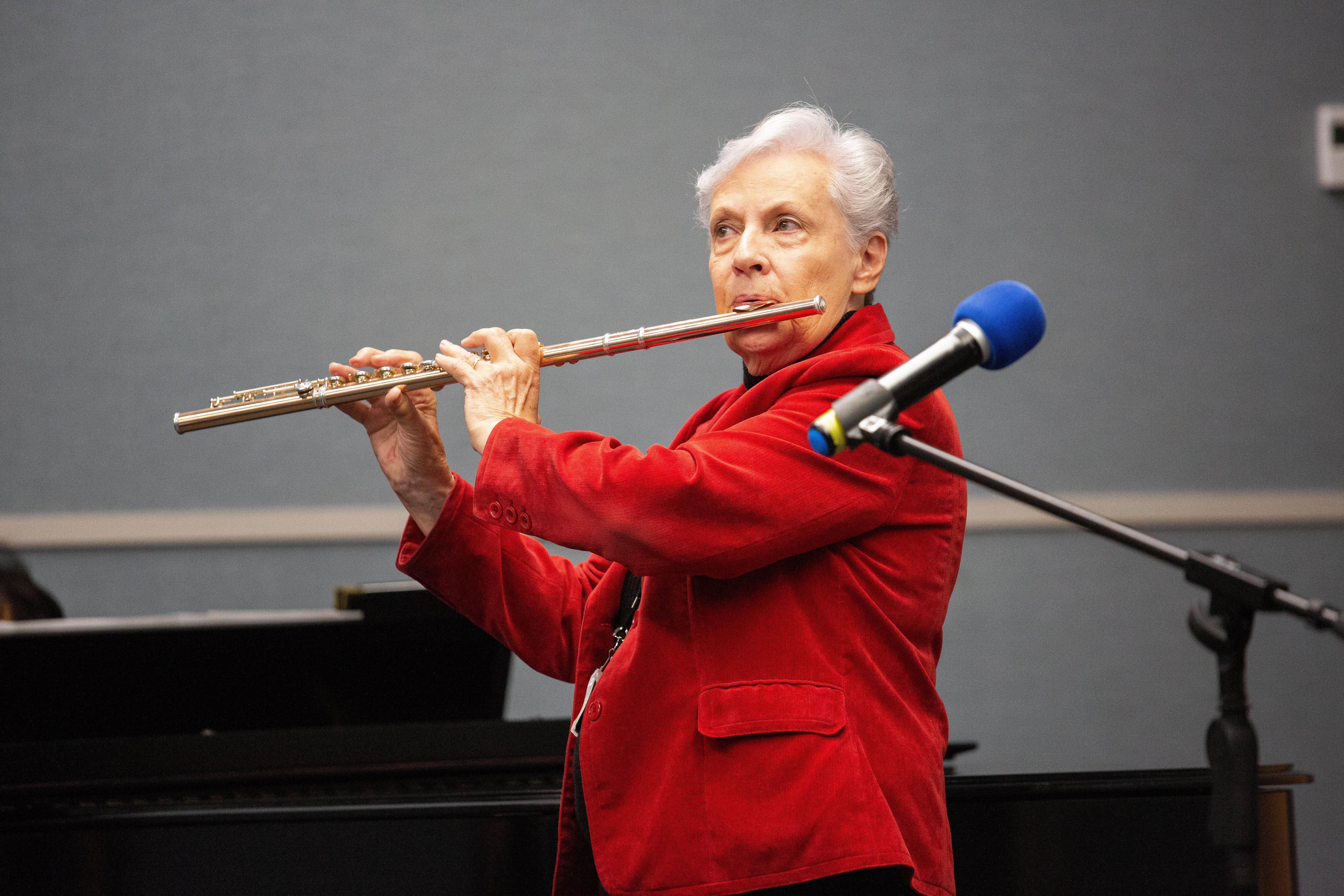 Lilya Wagner, director of PSI, plays her flute for the worship service on National Philanthropy Awareness Day.