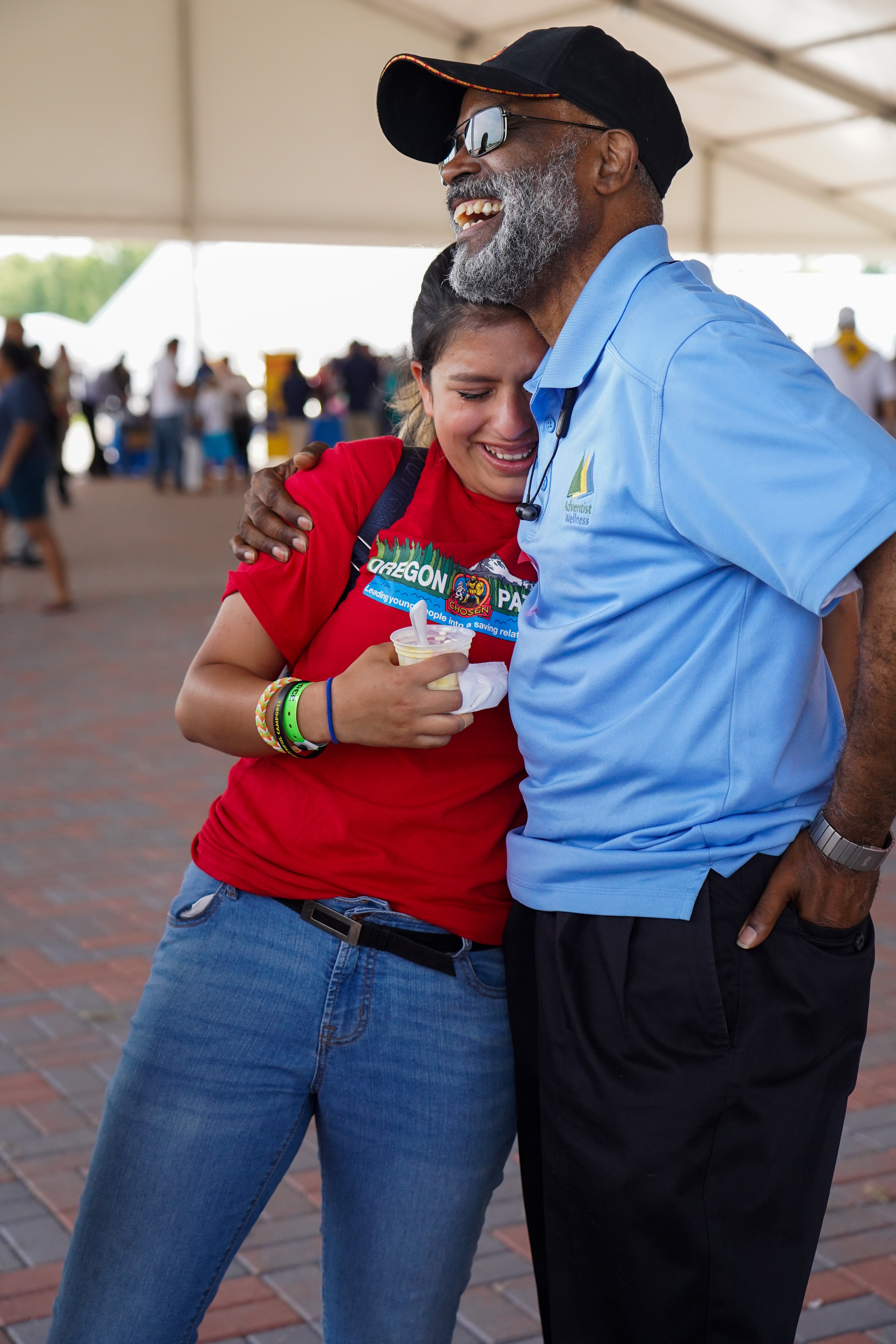 Byron Dulan, vice president for regional affairs of the North Pacific Union Conference, embraces Ashley Castro, a Pathfinder from the Oregon Conference, after she shares her desire to become pastor.