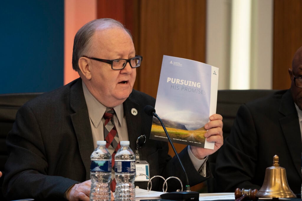 Daniel R. Jackson, holds up the program for the 2019 Year-End Meeting of the North American Division.
