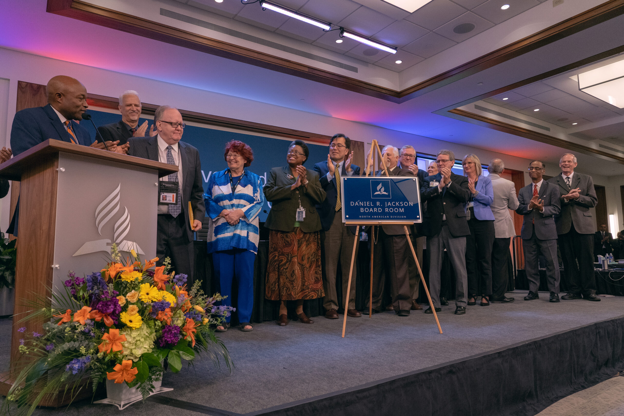 NAD leaders applaud Daniel R. Jackson, president of the NAD, after the unveiling a wall plaque bearing the new name of the building’s executive boardroom — “Daniel R. Jackson Executive Boardroom.”