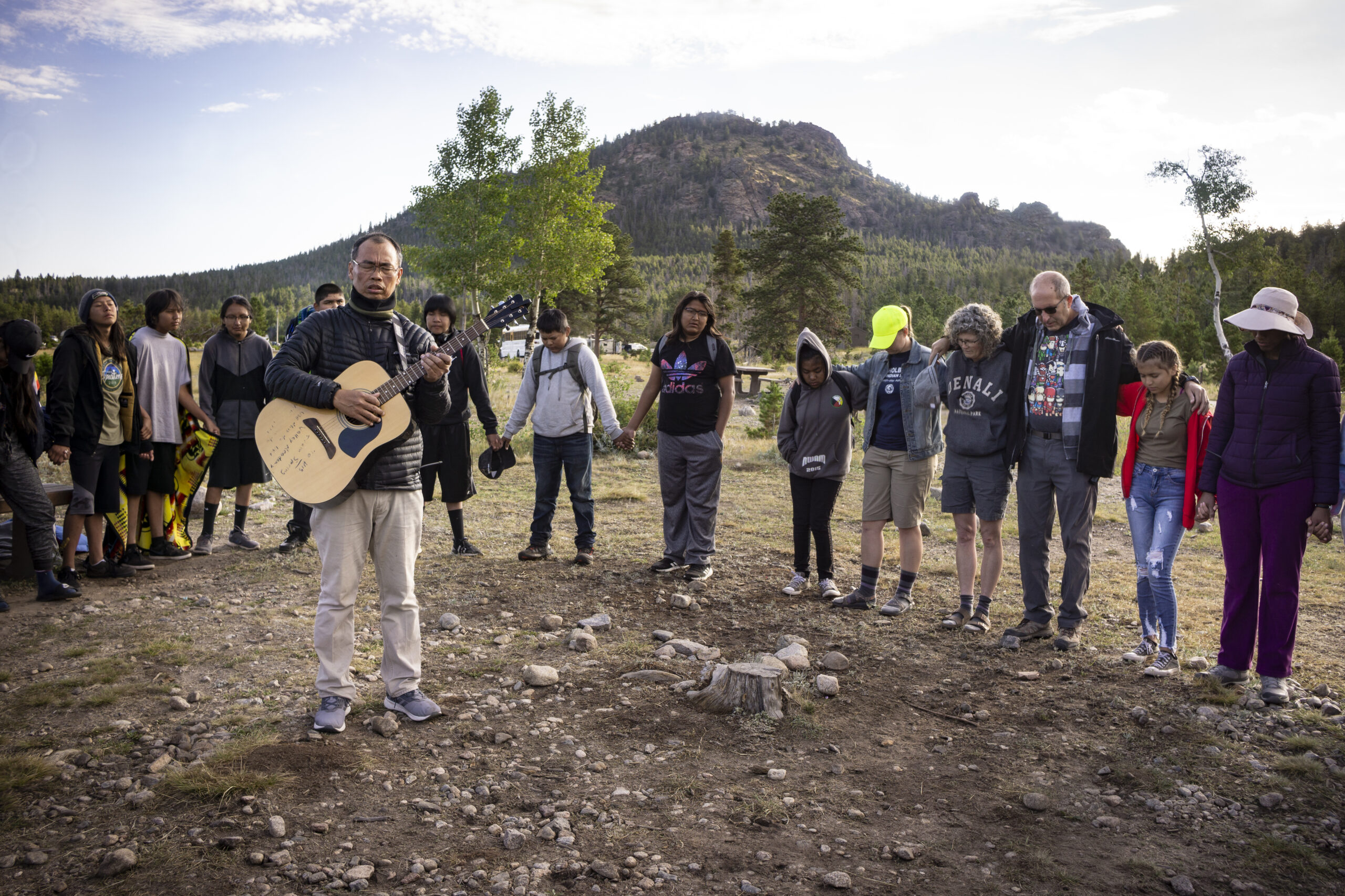 Students and teachers of Holbrook Indian School join hands as they sing and pray during a gathering last school year.