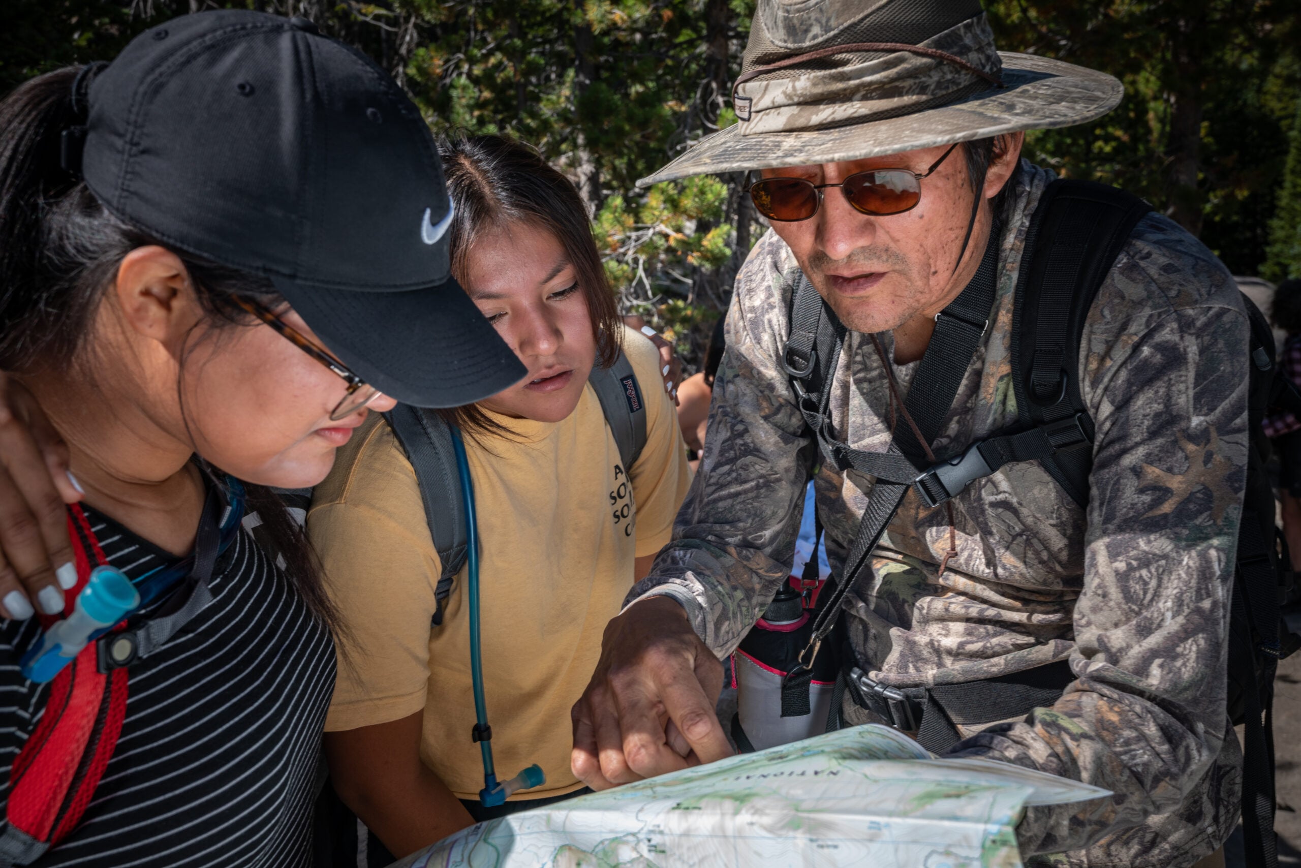 A teacher of Holbrook Indian School assists students with map reading as part of Holbrook’s “Outdoor School.”