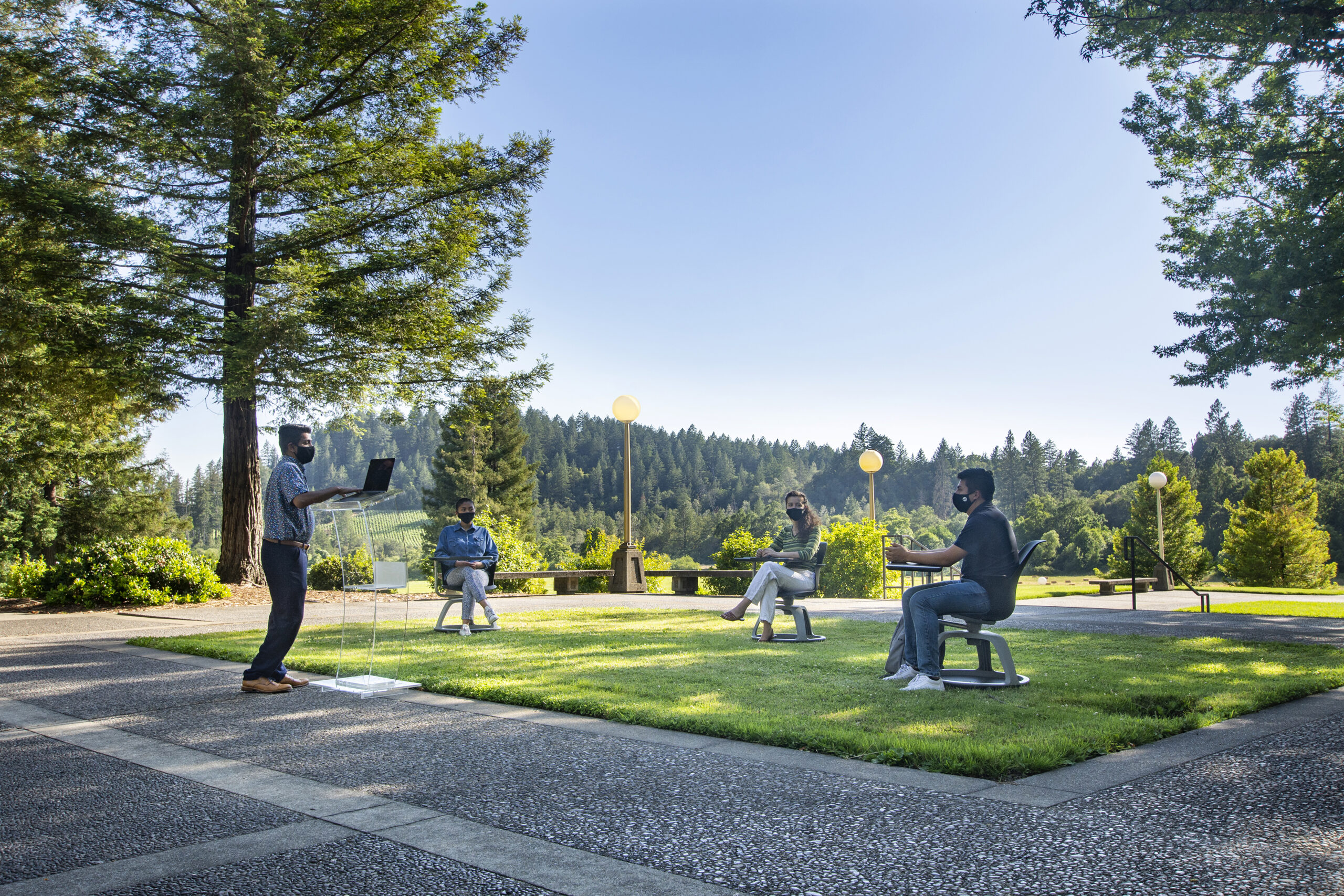 Rajeev Sigamoney, professor of film for Pacific Union College, leads a class outdoors on the school’s campus while exercising social distancing protocols.
