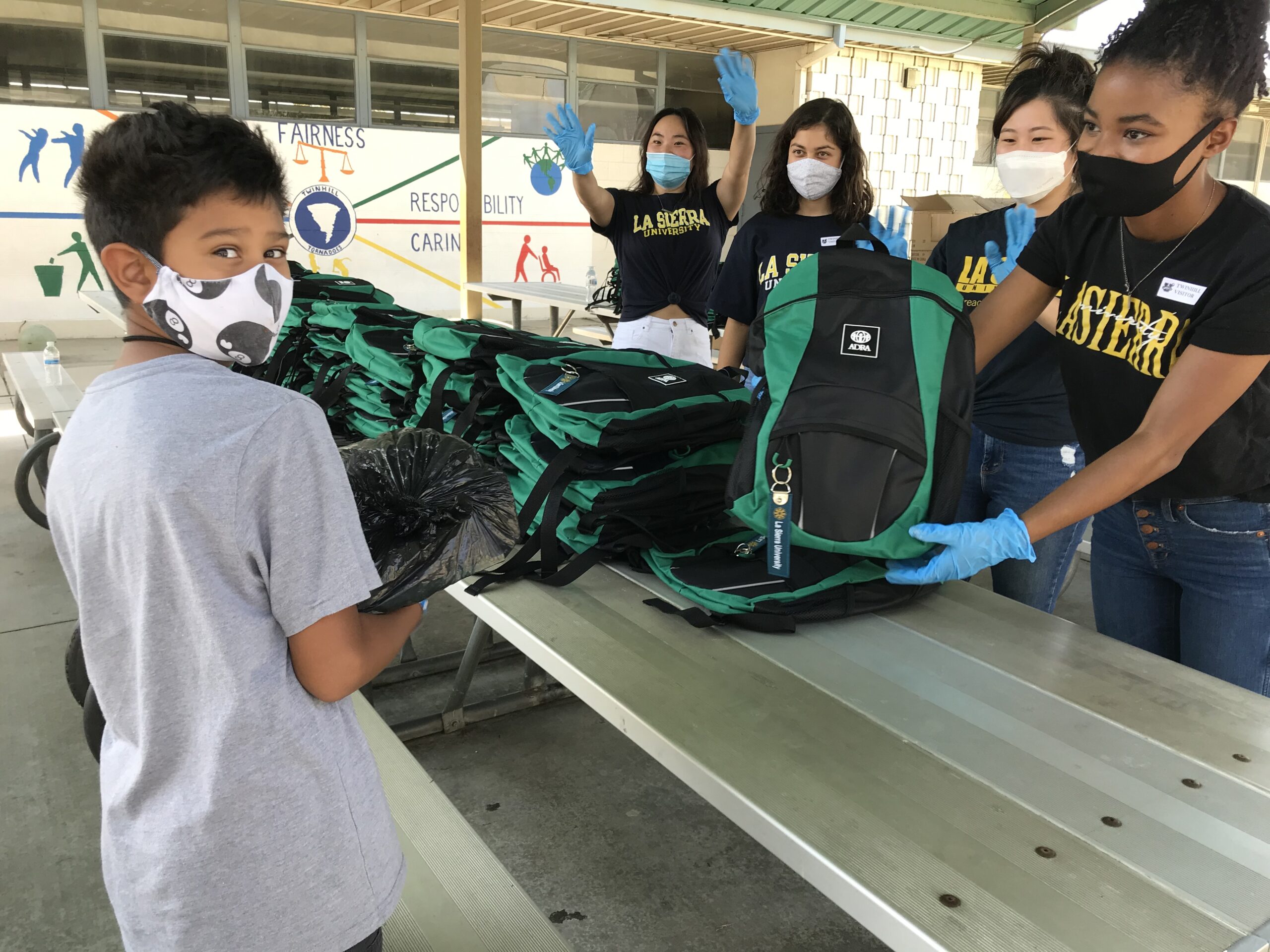 Third and 4th graders at Riverside’s Twinhill Elementary received filled backpacks on Friday, Aug. 28 a joint outreach between ADRA International and La Sierra University. La Sierra students left to right, Emily Suk, Shailani Skoretz, Ashley Peak and Jodi Wilson.