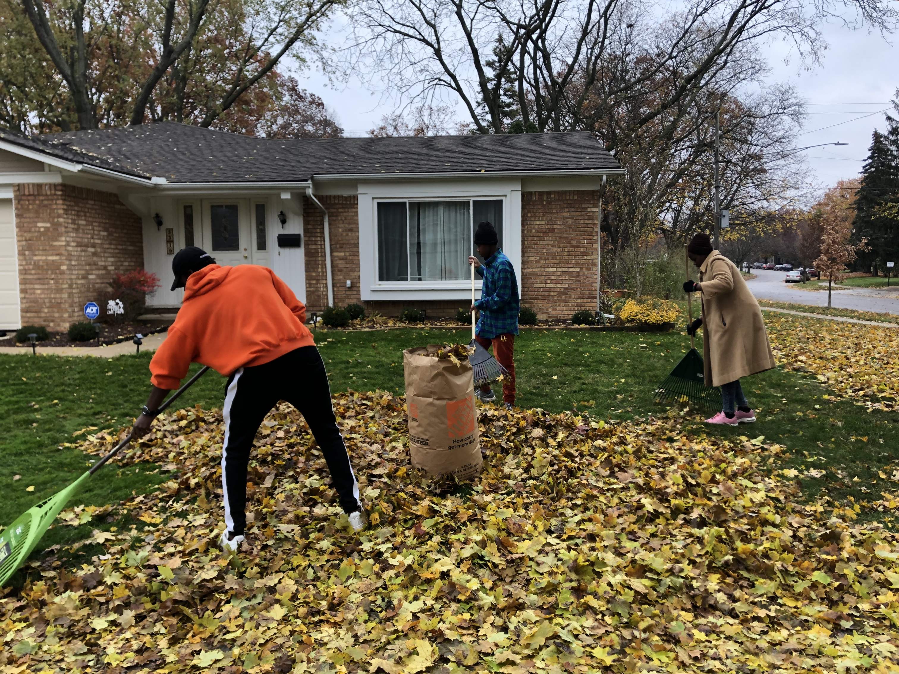 Karen Yang, family ministry director of the Ann Arbor Church, visited community houses with a group of refugee youth to rake leaves in exchange for donations.