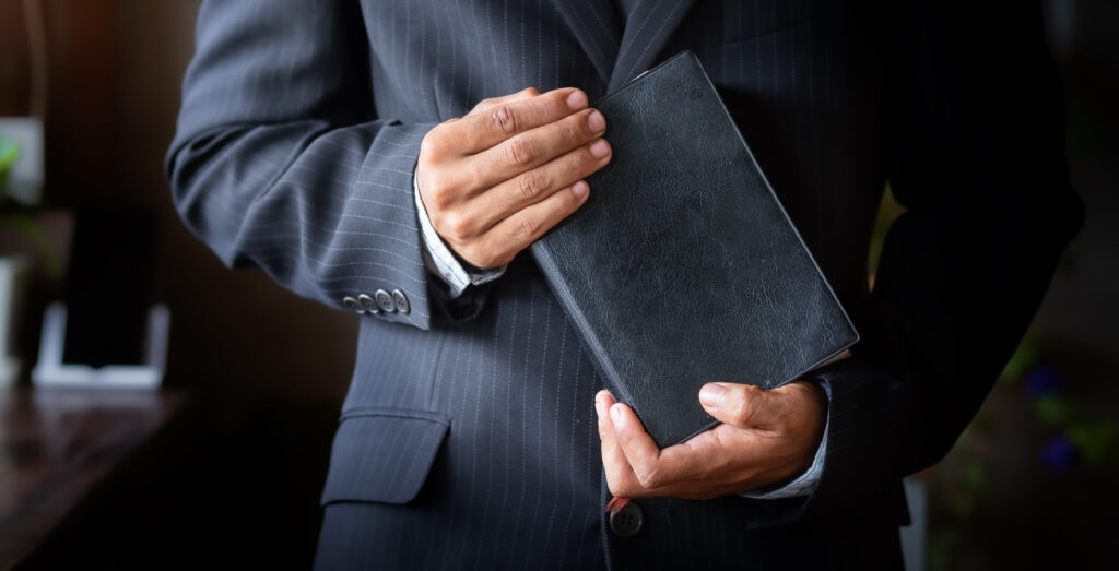 stock photo of man in suit with bible