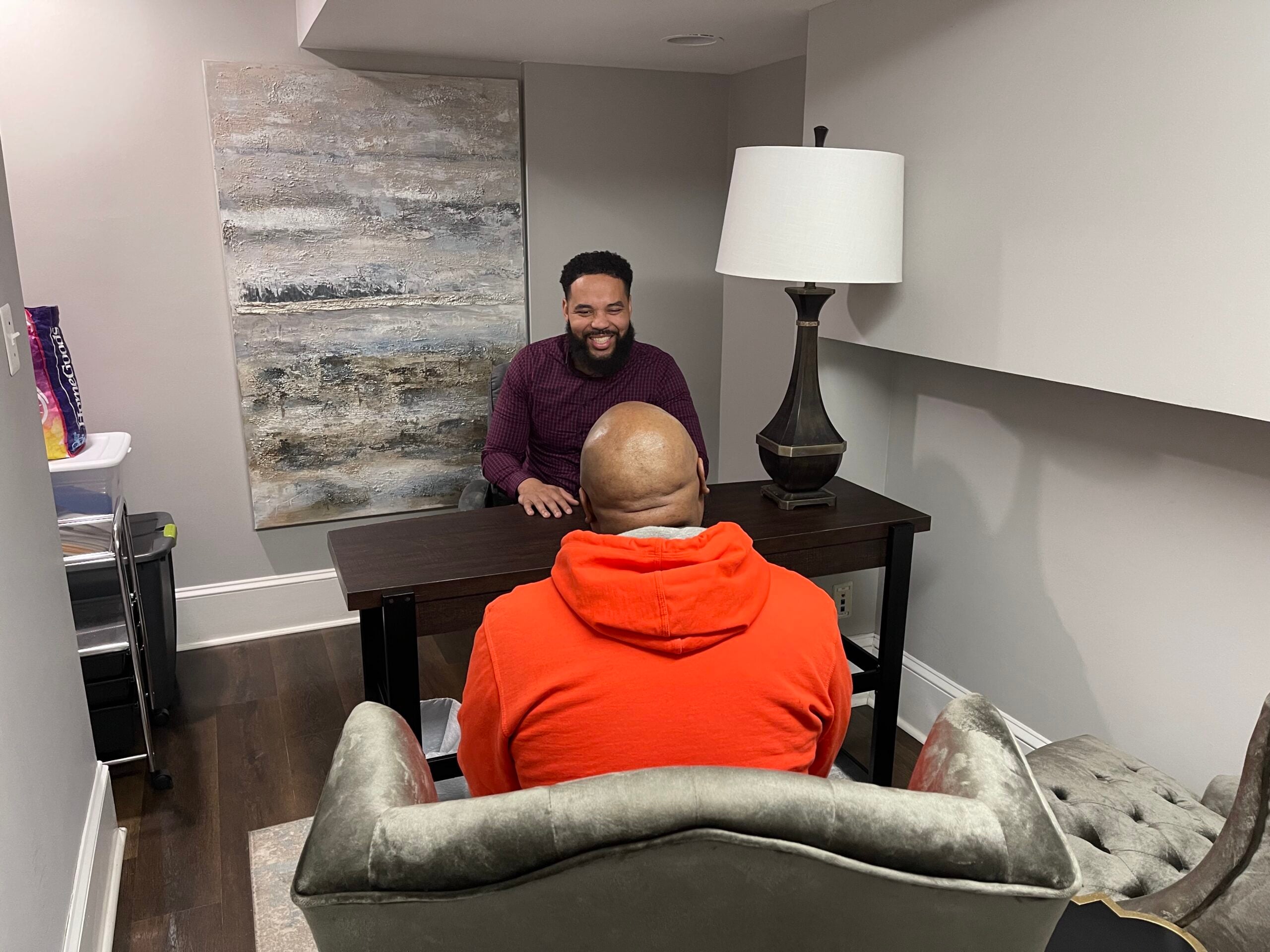 1)	Mario Broussard, licensed clinical social worker, is lead counselor for the resource center arm of the Capitol Hill Counseling and Resource Center, also an urban center of influence; here, he's seated across from a client.
