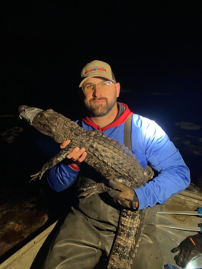 Jared Woods with gator at night