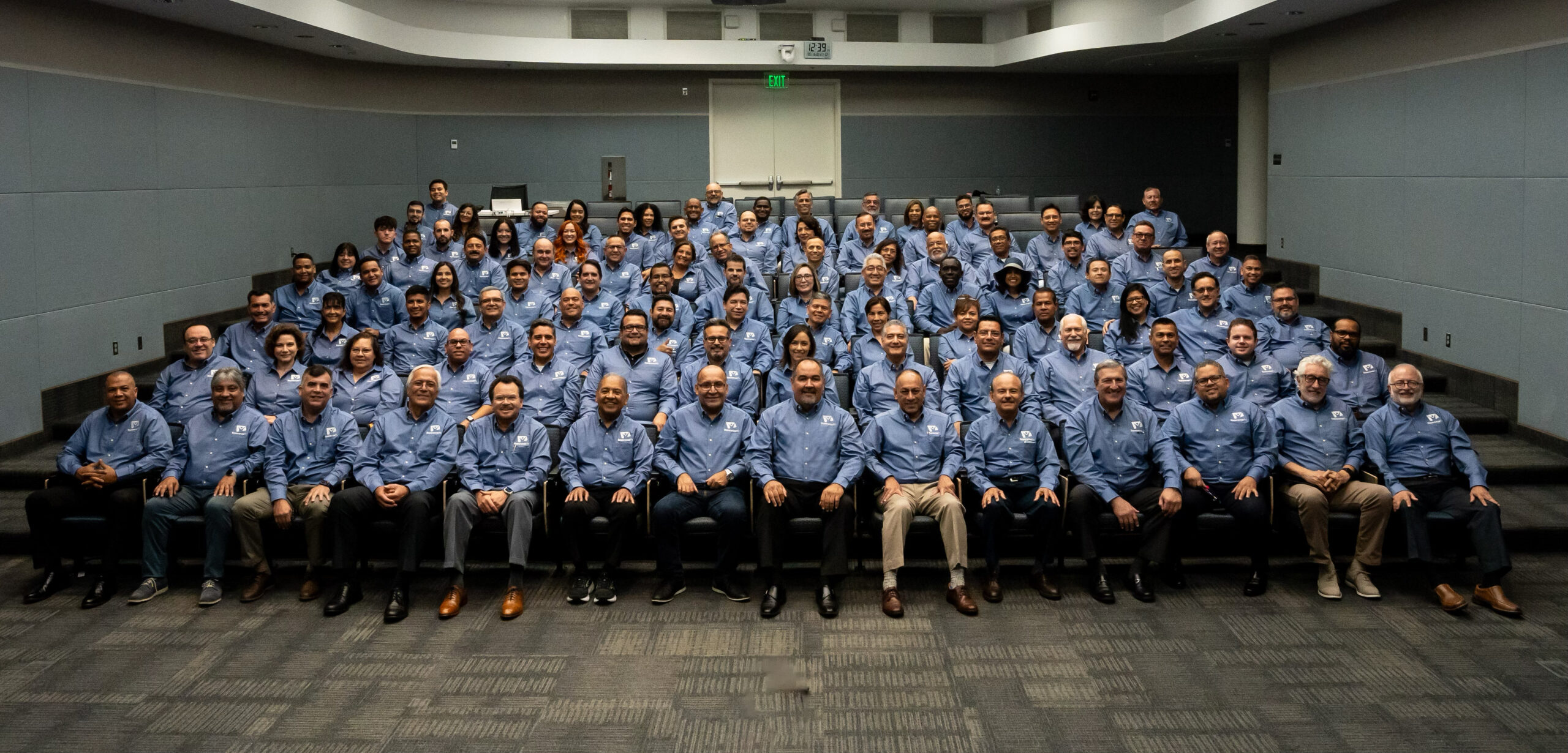 Group of people with matching blue shirts.