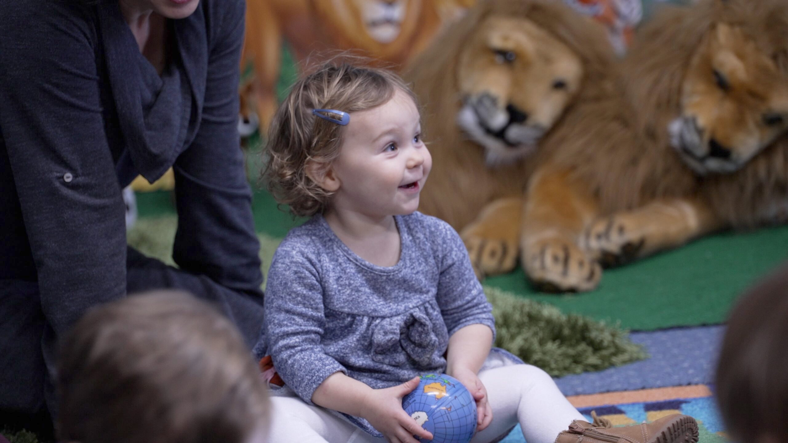 Toddler girl smiles during Sabbath School