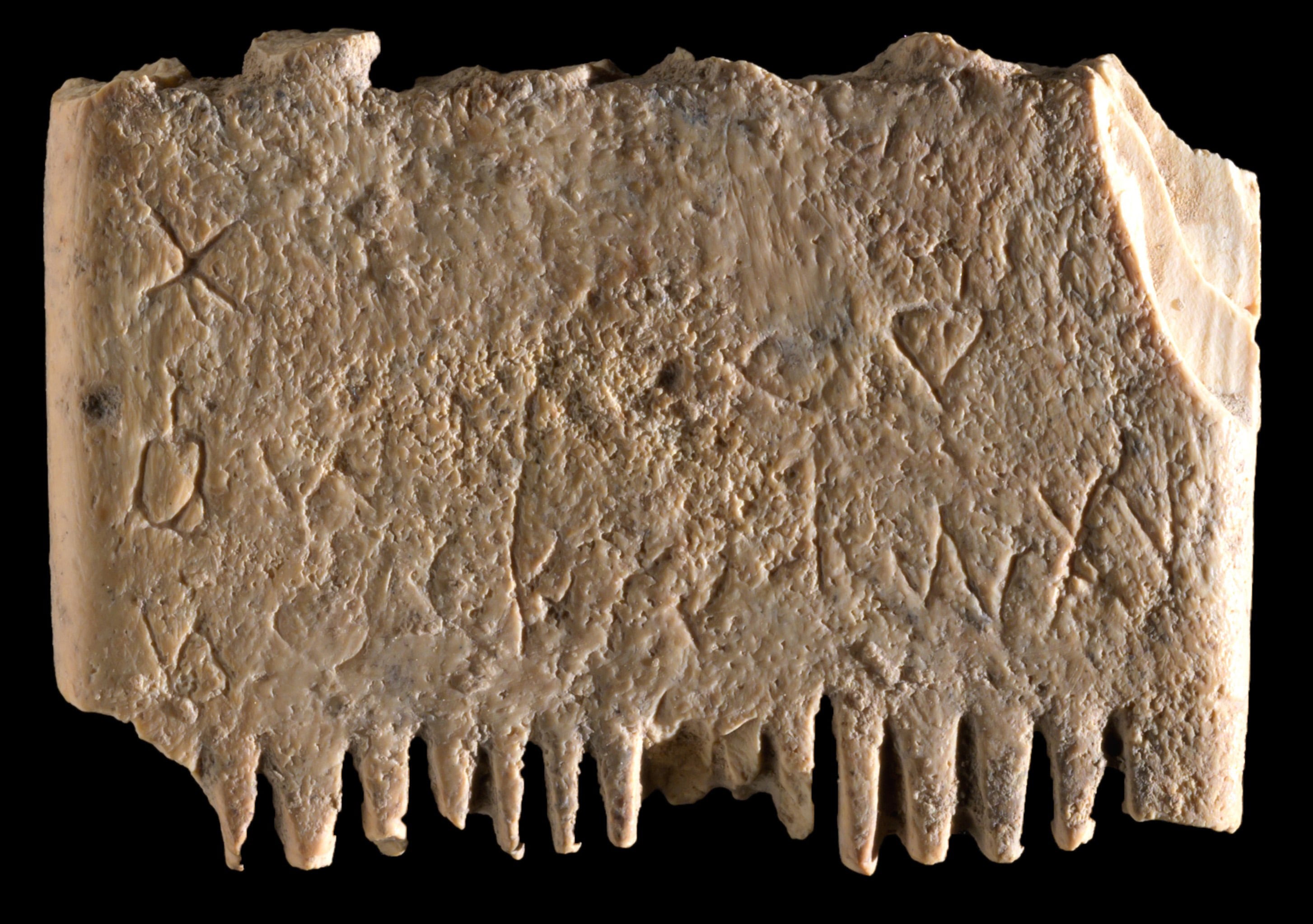 A close-up of a comb with Canaanite writing on it.
