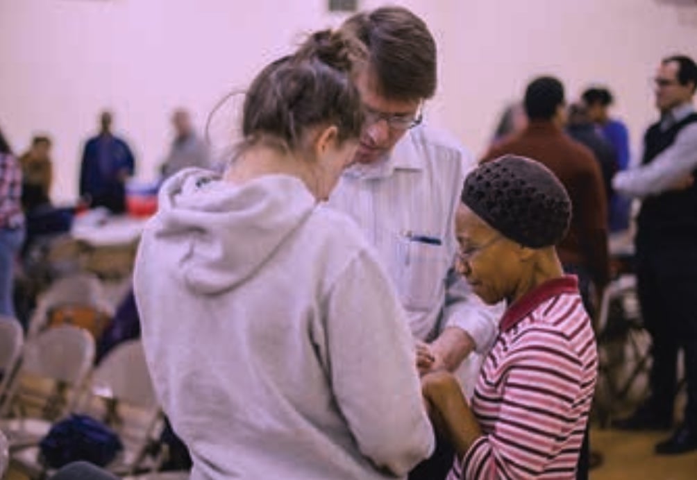 volunteers praying for the work