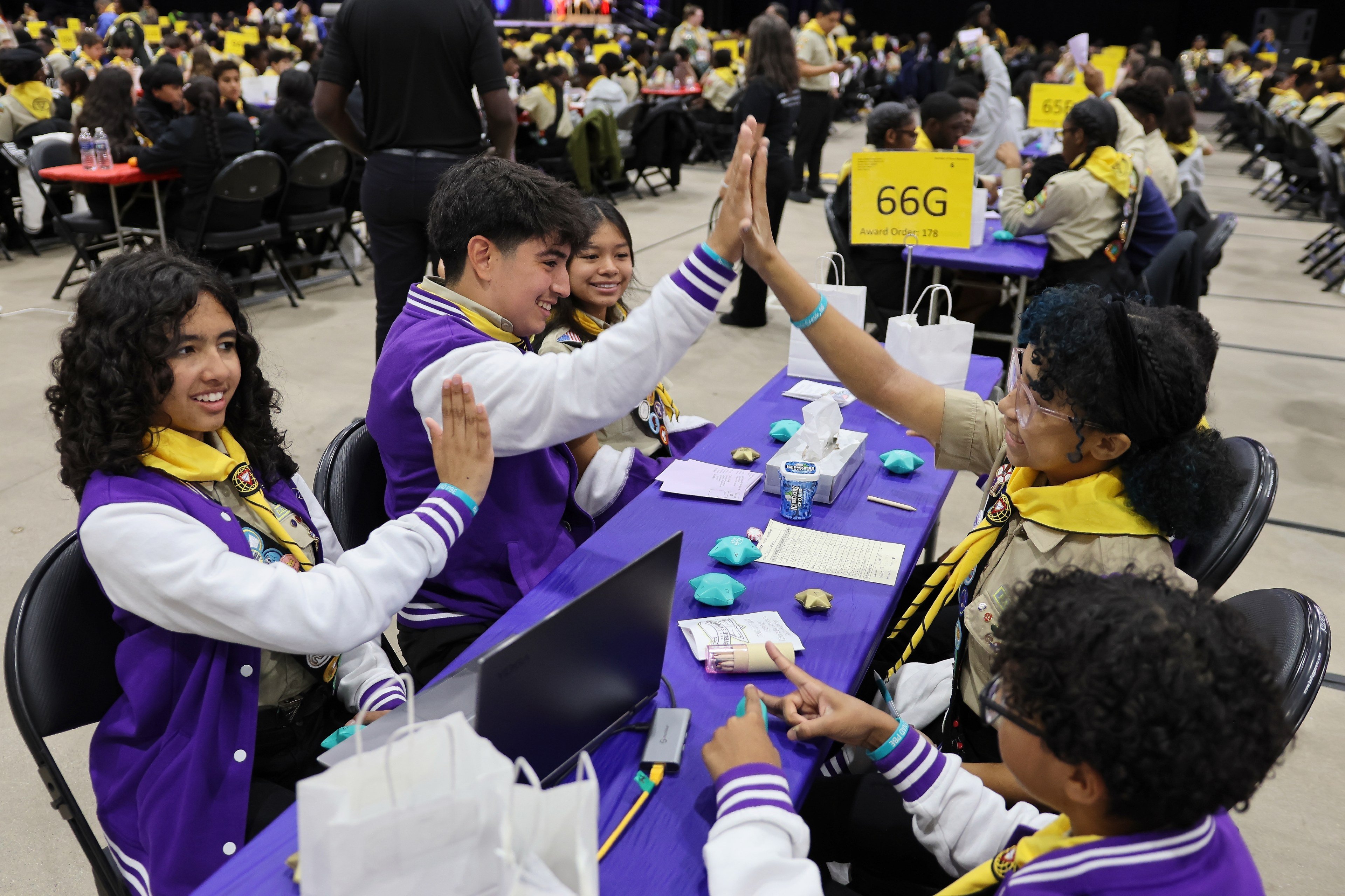 A team high-fives during the Pathfinder Bible Experience competition.