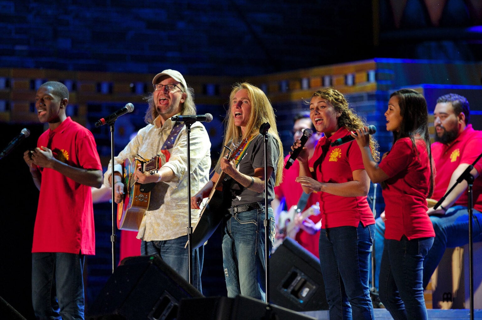 A group of musicians on a stage lead a praise and worship music session