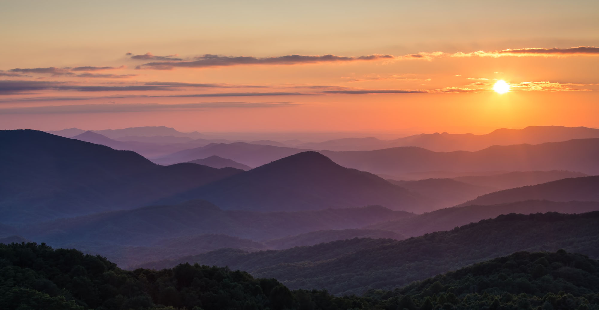 Sunset over the Appalachian Mountains, the hills purple with the coming night