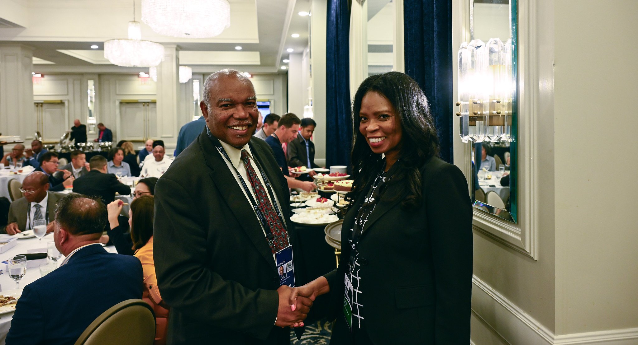 Two black people, a man and a woman, shaking hands