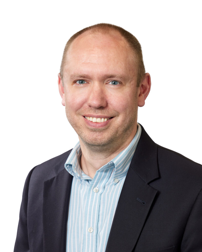 Headshot of a smiling man