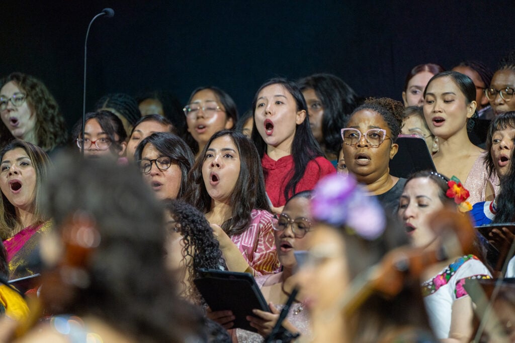 Close-up of women of diverse ethnicities singing