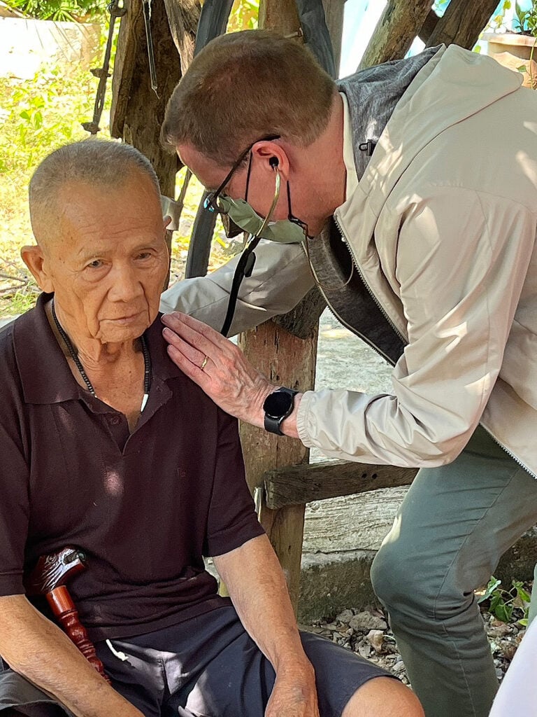 A doctor treats an elderly patient