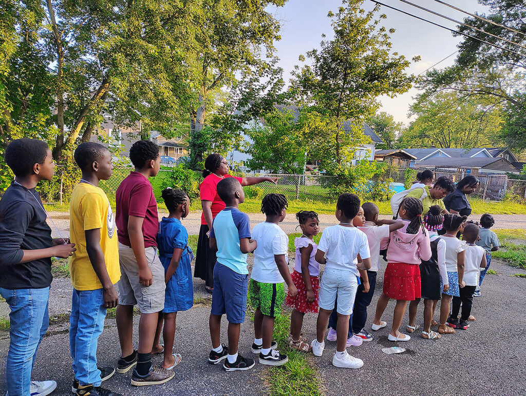 A line up of children outside with VBS leaders