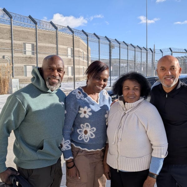 2 women and 2 men standing in front of a correctional facility.
