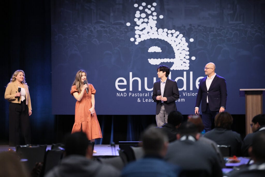 A family, mother, daughter, father, son, speak on the eHuddle stage. 