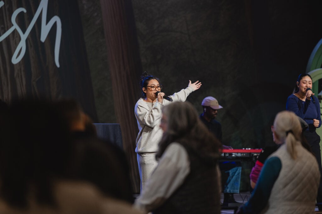 A praise team performs on a stage. 