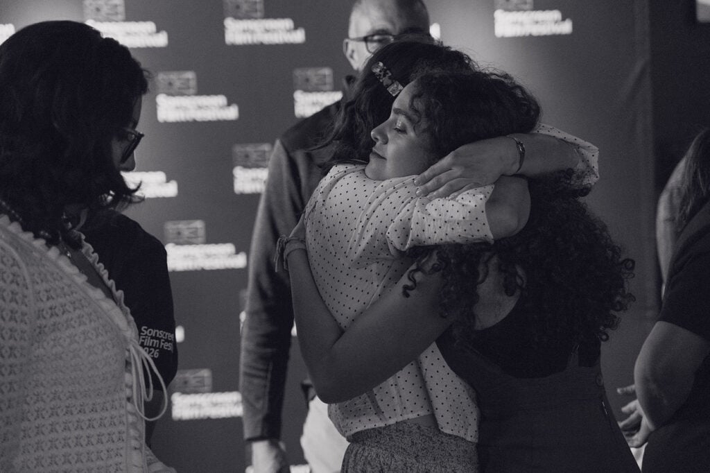 Black and white of two women hugging during Sonscreen Film Festival.