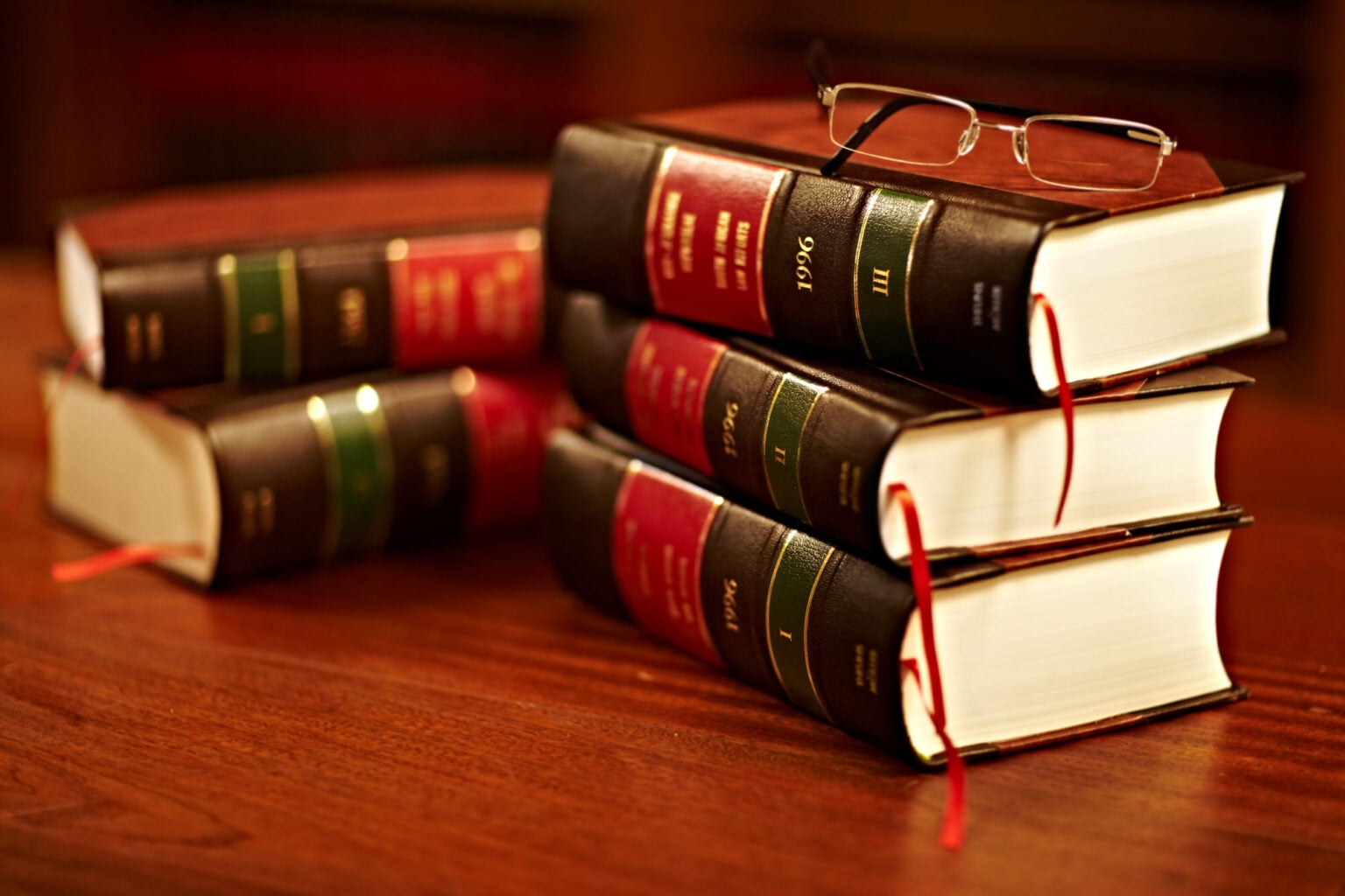 Stacked law books with a pair of glasses on top