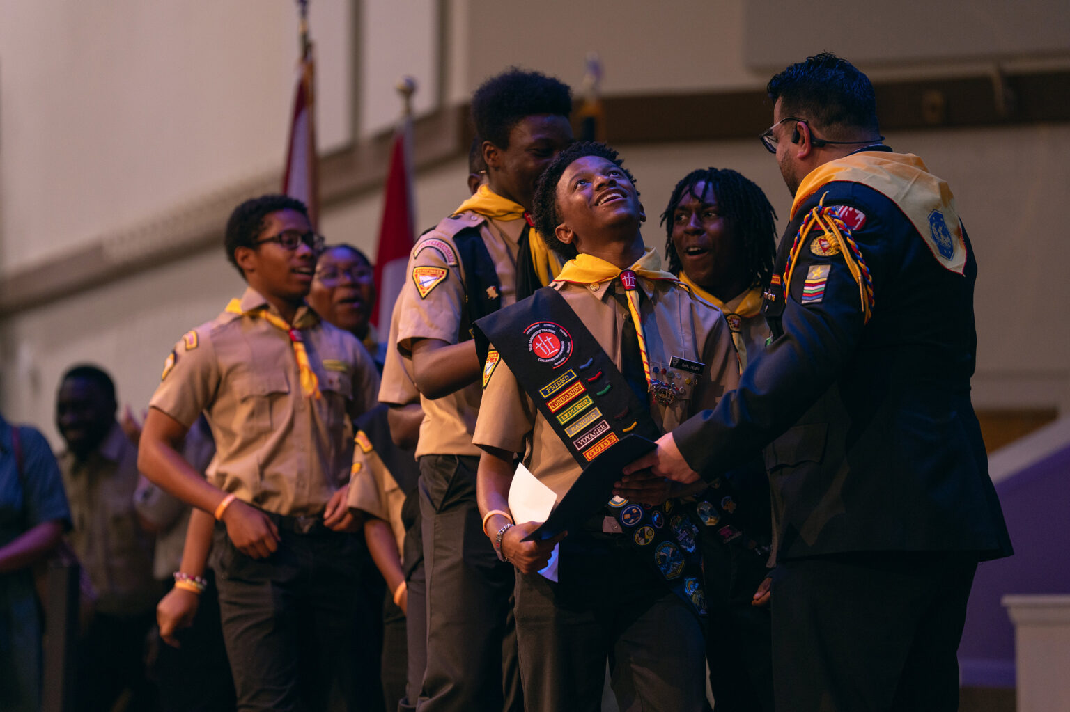 A Pathfinder team collects their certificates from Pathfinder Bible Experience organizer Armando Miranda on stage.
