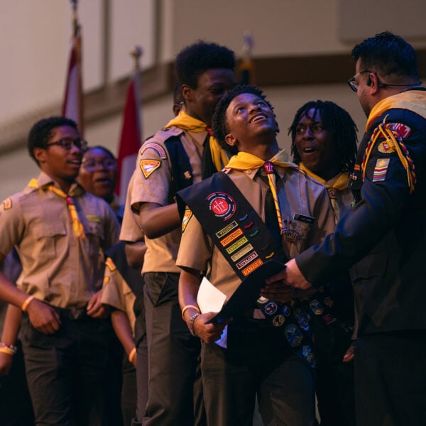 A Pathfinder team collects their certificates from Pathfinder Bible Experience organizer Armando Miranda on stage.