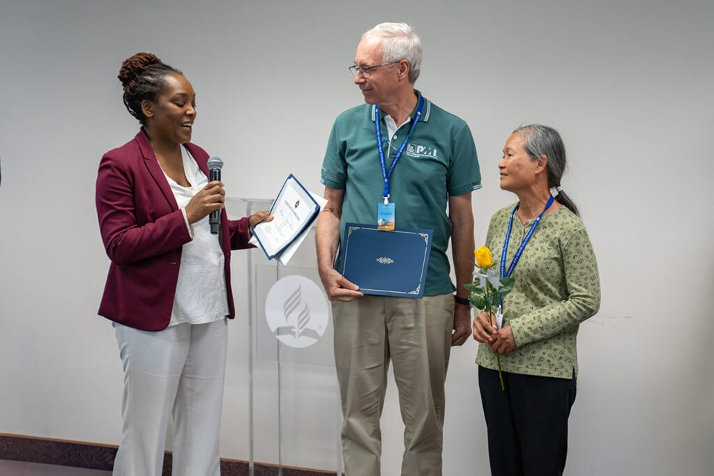 Orna Garnett gives the Hamras their certificate.