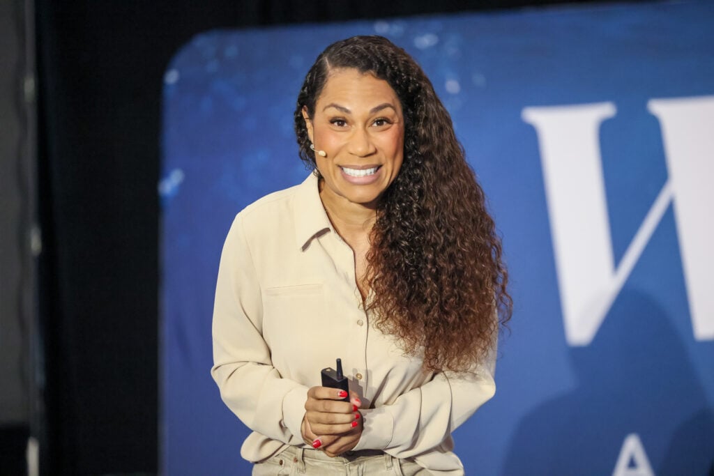 Close-up of a smiling woman preparing to speak 