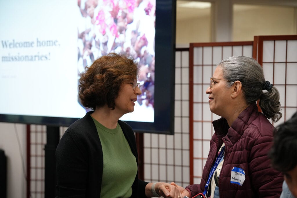 Close-up of two women speaking warmly