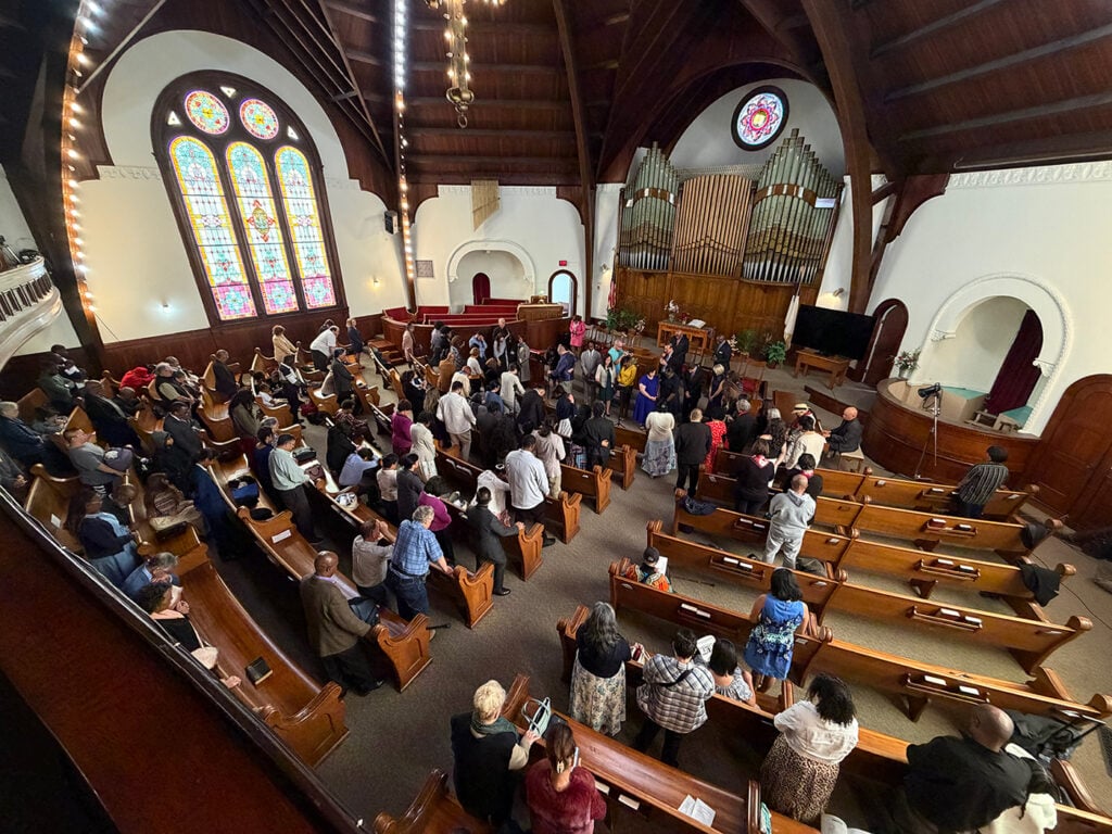 Wide shot of a congregation at worship